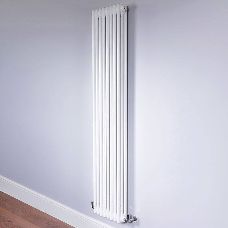 Vertical three column radiator in a white room